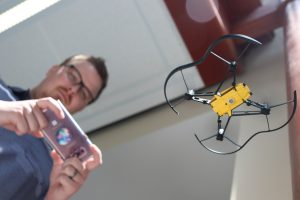 UConn Educational Technology graduate student flies a drone using a smartphone application